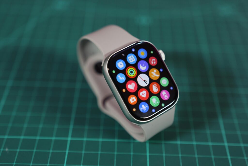Close-up of a smartwatch showcasing various colorful app icons on its screen.